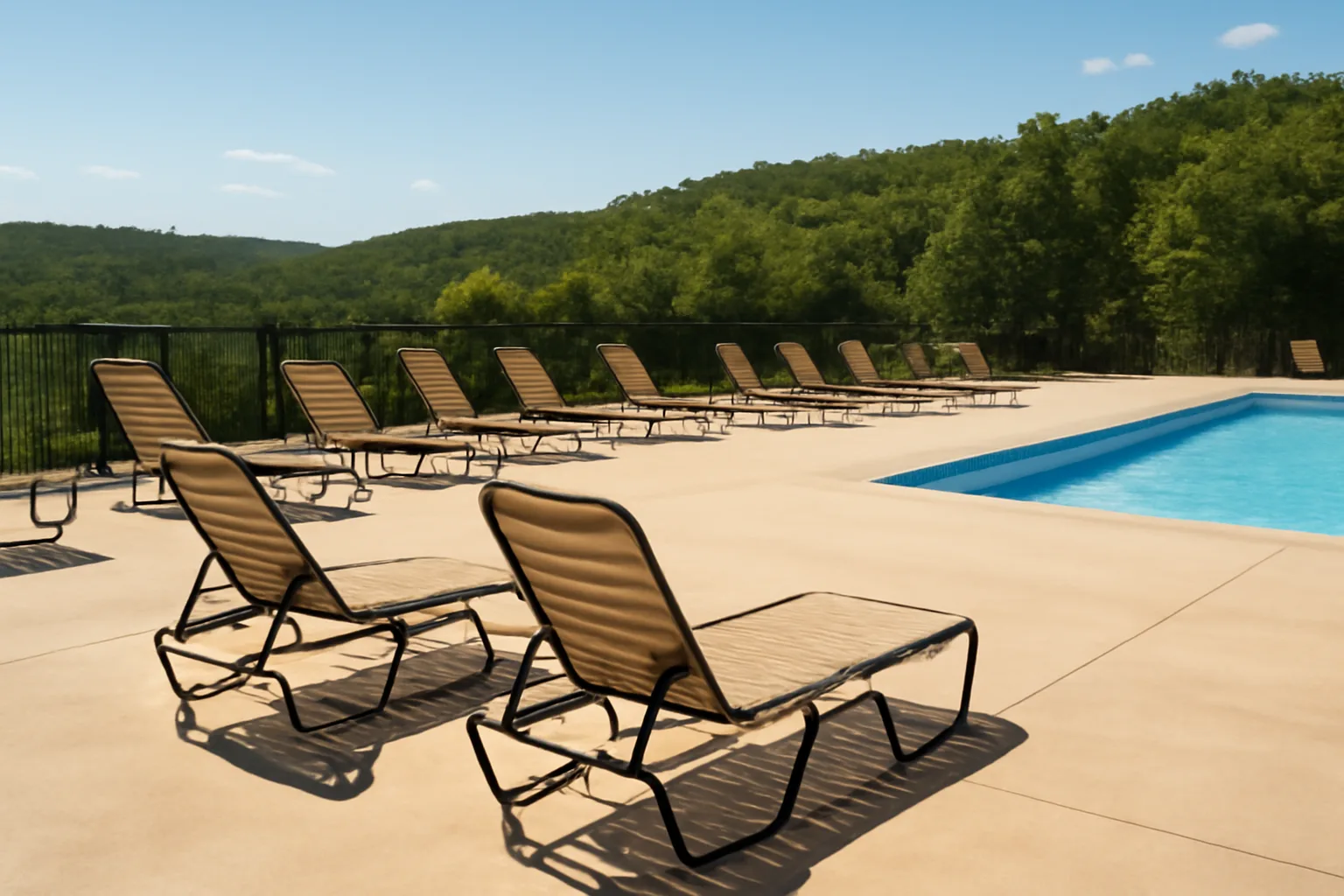Empty resort pool deck with lounge chairs in Missouri Ozarks, representing Silverleaf timeshare properties